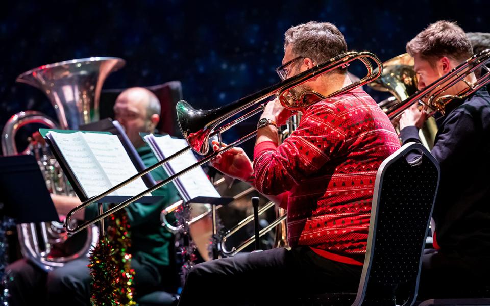 Brass players wearing Christmas jumpers