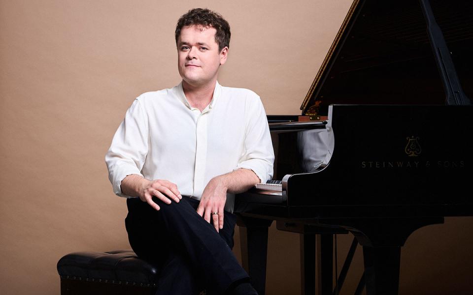 Benjamin Grosvenor sat at the piano, facing the camera