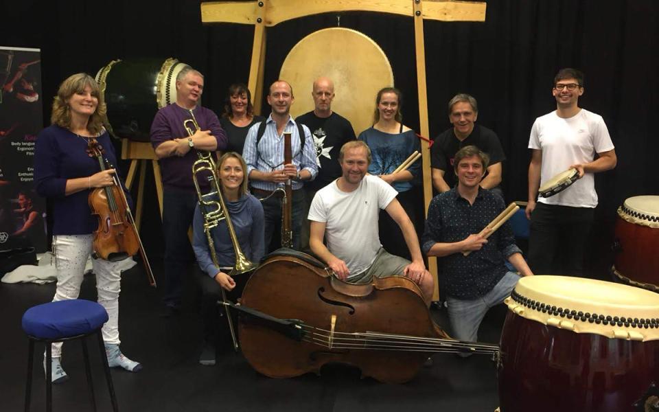 Musicians of the Philharmonia posing with their instruments and taiko drums