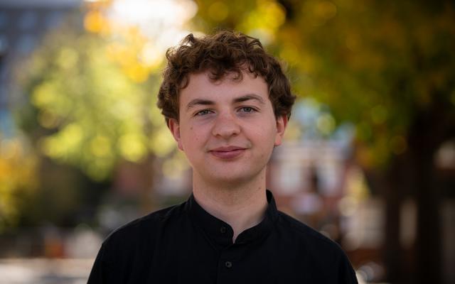 Eddie smiling at camera outside Philharmonia office